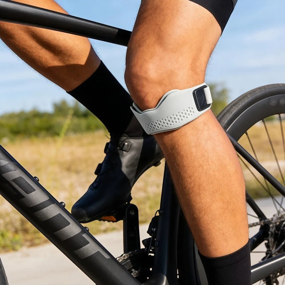 zero2cart gray adjustable patellar tendon support strap worn by a cyclist for knee stability during outdoor riding