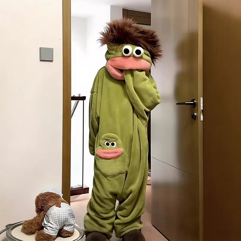 Person wearing a zero2cart green monster fleece onesie pajama with a brown fuzzy hood and cartoon face pocket