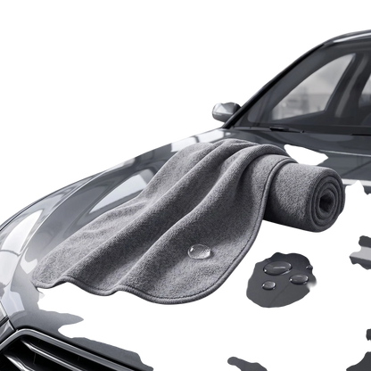 zero2cart grey microfiber car drying towel resting on a wet car hood with water droplets