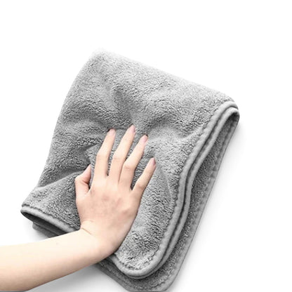 zero2cart grey microfiber car drying towel with a soft, plush texture held by a hand against a black background