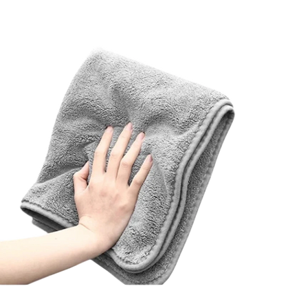 zero2cart grey microfiber car drying towel with a soft, plush texture held by a hand against a black background