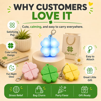zero2cart light-up four-leaf clover pop-it fidget keychains in green, pink, yellow, and glowing blue silicone.