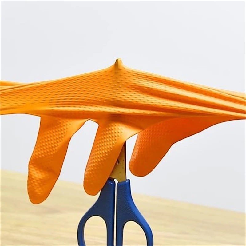 zero2cart heavy duty orange nitrile gloves with raised diamond texture being stretched over scissors for durability