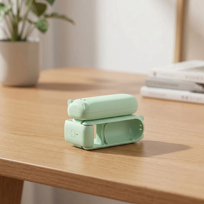zero2cart light green portable foldable mini fan resting on a wooden desk for personal cooling