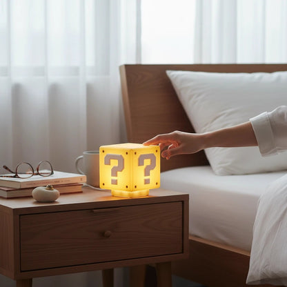 zero2cart rechargeable yellow question mark brick LED night light on a wooden bedside table with a hand touching it