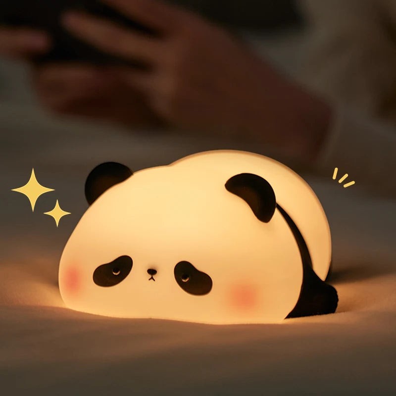zero2cart rechargeable panda night light with soft silicone body emitting a warm glow on a bed