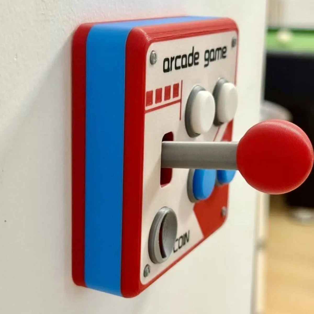 zero2cart retro arcade style light switch cover in red, white, and blue ABS plastic with a joystick design