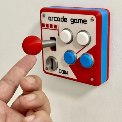 zero2cart retro arcade light switch cover with red joystick and colorful buttons mounted on a white wall