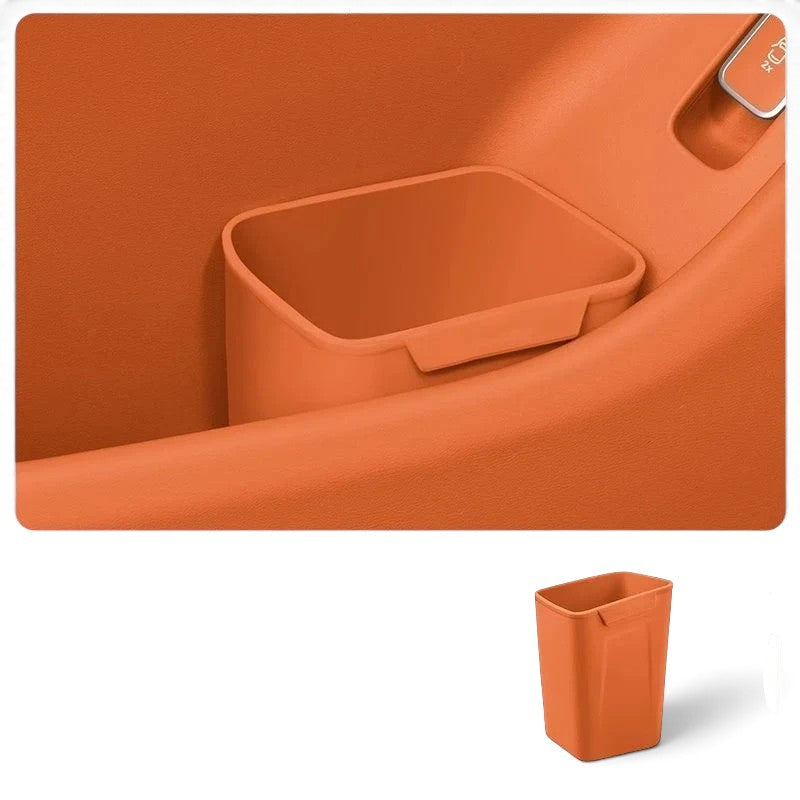 zero2cart orange silicone car door trash bin and organizer clipped onto a vehicle door panel