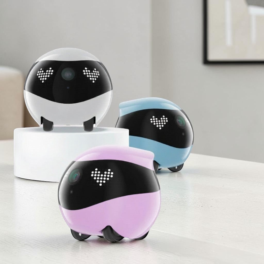 zero2cart smart pet camera robots in white, blue, and pink with heart-shaped LED eyes on a white table