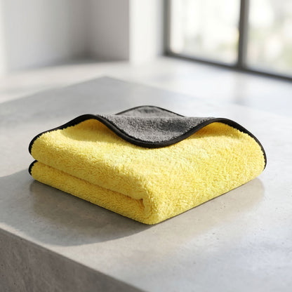 zero2cart soft yellow and grey microfiber cleaning towel folded on a concrete surface for car and home use